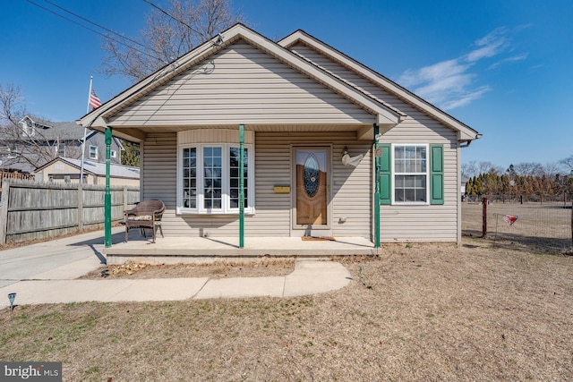 view of front facade featuring a porch and fence