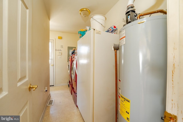 utility room with gas water heater, visible vents, and independent washer and dryer