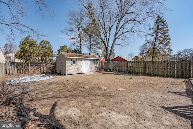 view of yard featuring a fenced backyard and an outdoor structure