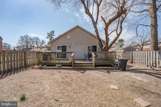 back of house with a fenced backyard and a wooden deck