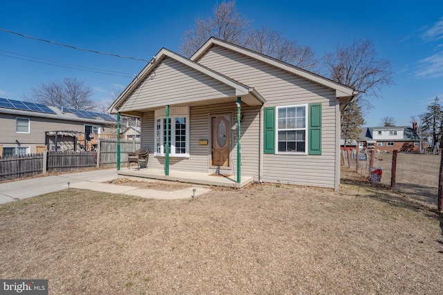 bungalow-style home with a porch and fence