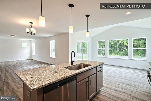 kitchen featuring open floor plan, dishwasher, wood finished floors, and a sink