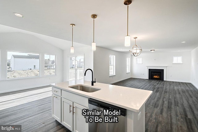 kitchen featuring an island with sink, a sink, dark wood finished floors, white cabinetry, and dishwasher