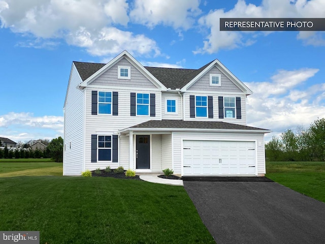 view of front of property featuring a shingled roof, a front yard, a garage, and aphalt driveway