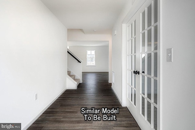 hallway with stairway, wood finished floors, and baseboards