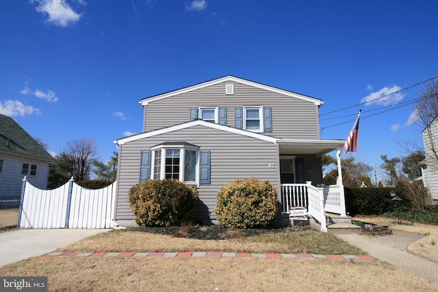 traditional home with a porch and a gate