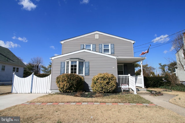 traditional-style house with a porch and driveway