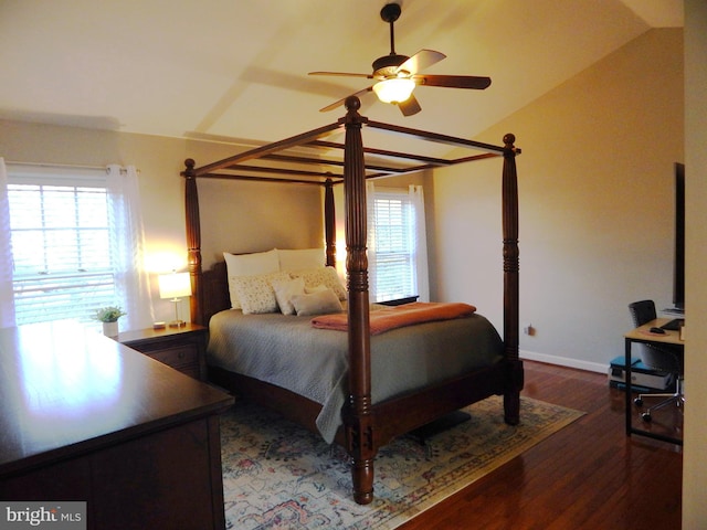 bedroom with lofted ceiling, wood finished floors, baseboards, and ceiling fan