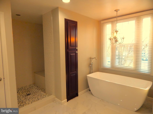 bathroom featuring baseboards, a soaking tub, a shower, a notable chandelier, and marble finish floor