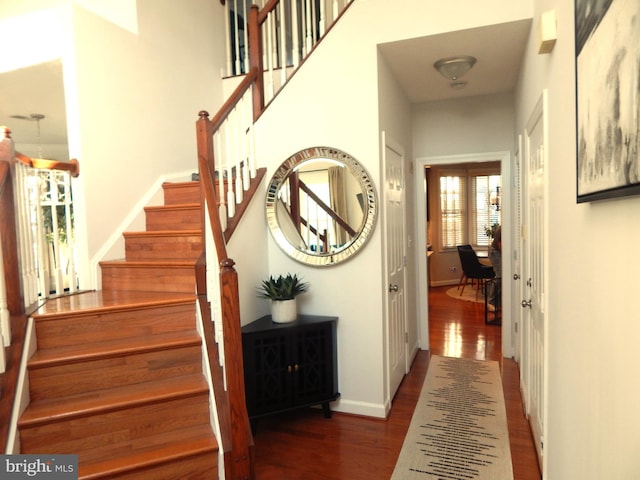 stairs featuring wood finished floors and baseboards