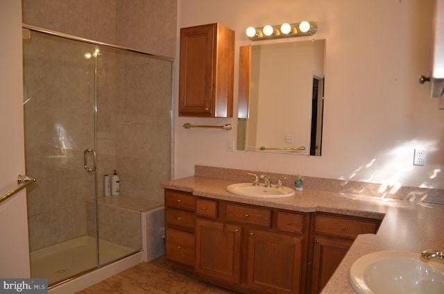 bathroom featuring vanity and a shower stall