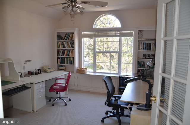 office space featuring lofted ceiling, light colored carpet, and a ceiling fan