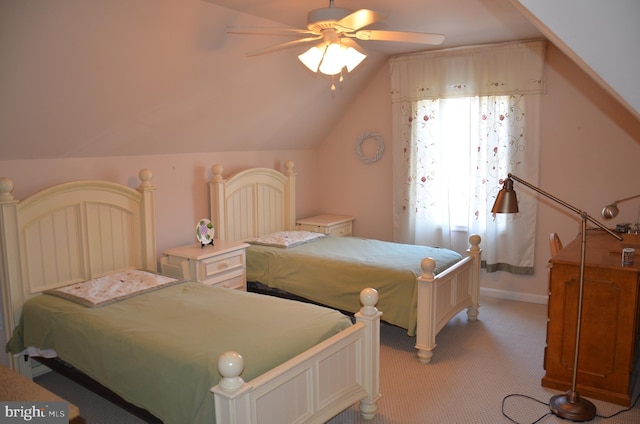 bedroom featuring a ceiling fan, lofted ceiling, light colored carpet, and baseboards