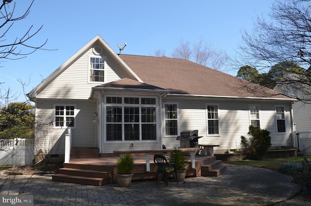 back of house with a shingled roof, a patio, fence, and crawl space