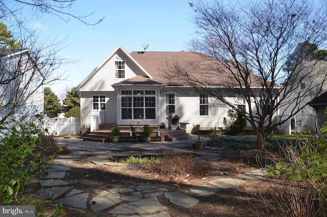 view of front of house featuring a wooden deck and fence