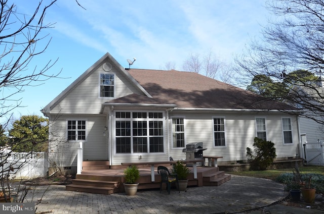 back of house featuring a patio, fence, roof with shingles, a wooden deck, and crawl space