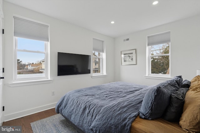 bedroom with visible vents, recessed lighting, wood finished floors, and baseboards