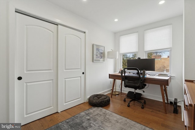 office space featuring recessed lighting, baseboards, and hardwood / wood-style flooring