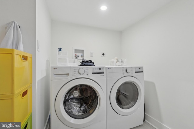 clothes washing area featuring washer and dryer, baseboards, recessed lighting, and laundry area