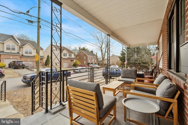 balcony featuring an outdoor living space and a residential view