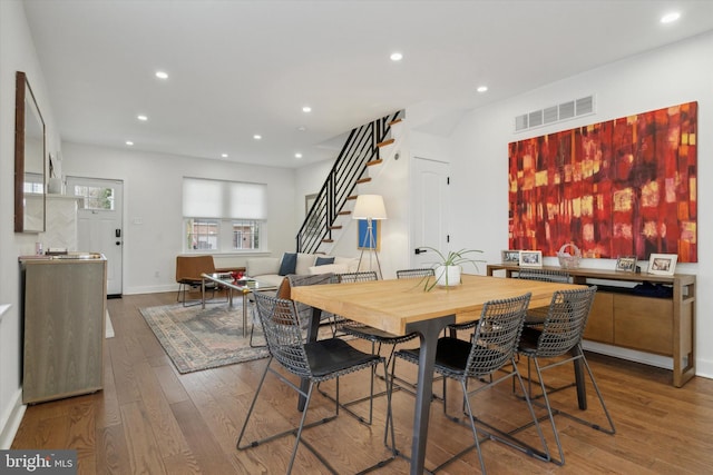 dining room with visible vents, recessed lighting, stairway, and hardwood / wood-style flooring