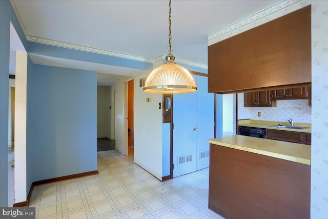 kitchen featuring visible vents, light floors, dishwasher, light countertops, and a sink