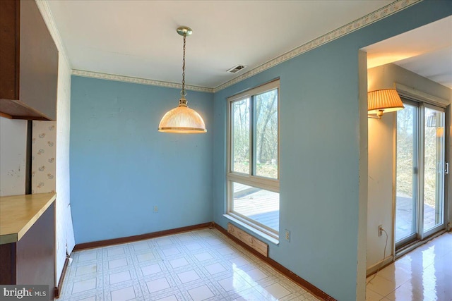 unfurnished dining area with baseboards, light floors, visible vents, and ornamental molding