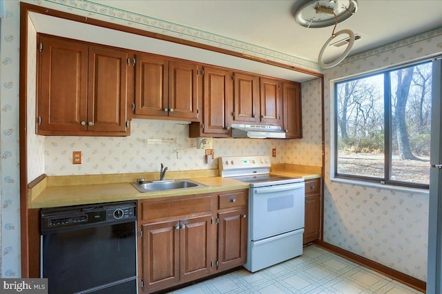 kitchen featuring wallpapered walls, under cabinet range hood, black dishwasher, white electric range oven, and a sink