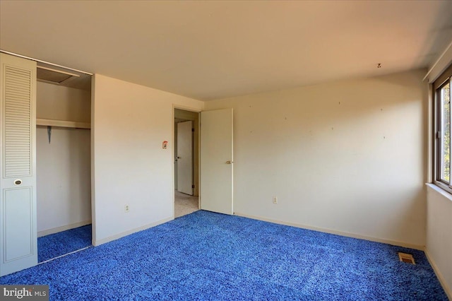 unfurnished bedroom featuring visible vents, baseboards, carpet, and a closet