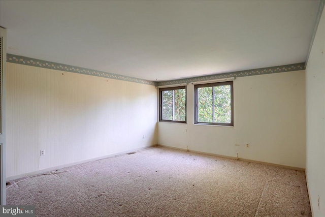 spare room with carpet and baseboards