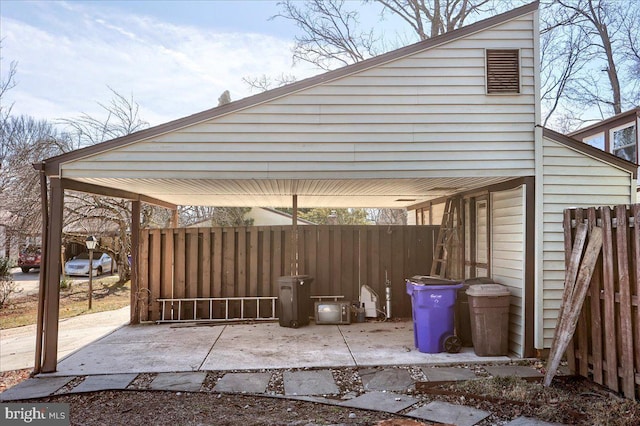 view of patio / terrace with a carport and fence