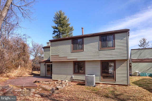 rear view of property featuring central AC unit