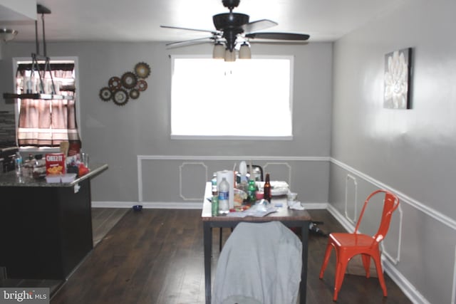 dining space with ceiling fan, baseboards, and wood finished floors