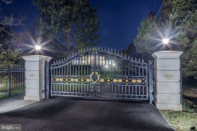 view of gate at night