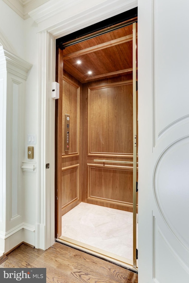 details featuring wood finished floors, elevator, and wood ceiling