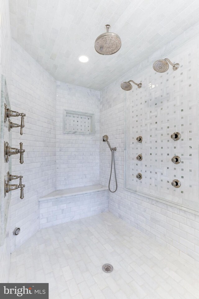 full bath featuring a tile shower