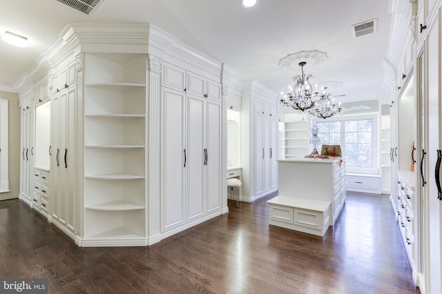 interior space with a chandelier, visible vents, and dark wood-type flooring