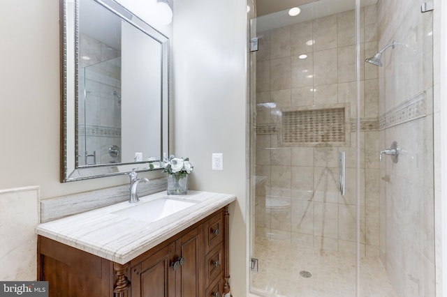 bathroom with a stall shower and vanity