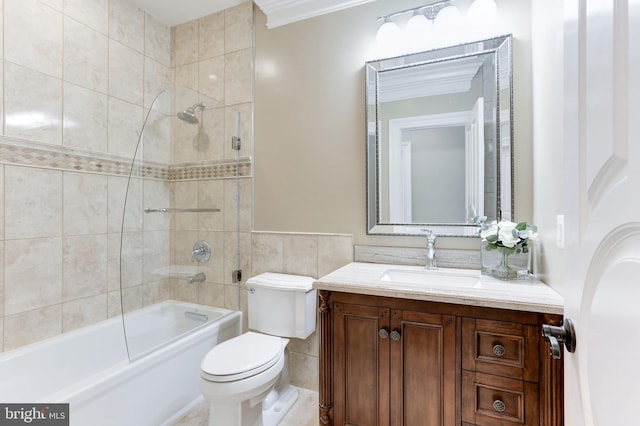 full bath with tile walls, crown molding, toilet, bathtub / shower combination, and vanity