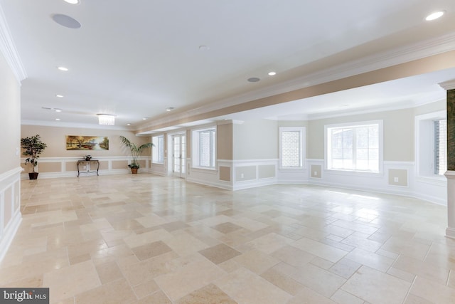 interior space with crown molding, a decorative wall, recessed lighting, and wainscoting