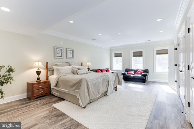 bedroom featuring light wood-type flooring, baseboards, and ornamental molding