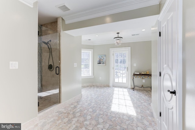 bathroom featuring visible vents, baseboards, a stall shower, and crown molding