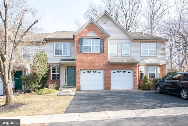 view of front of house with brick siding, driveway, and an attached garage