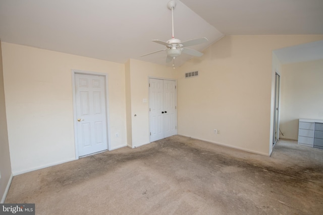 unfurnished bedroom featuring vaulted ceiling, carpet flooring, baseboards, and visible vents