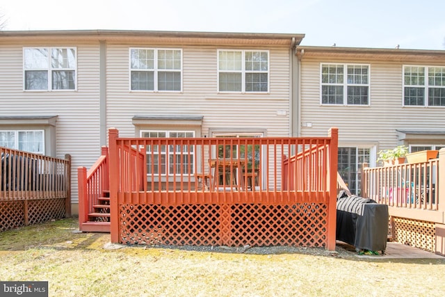 rear view of property featuring a wooden deck