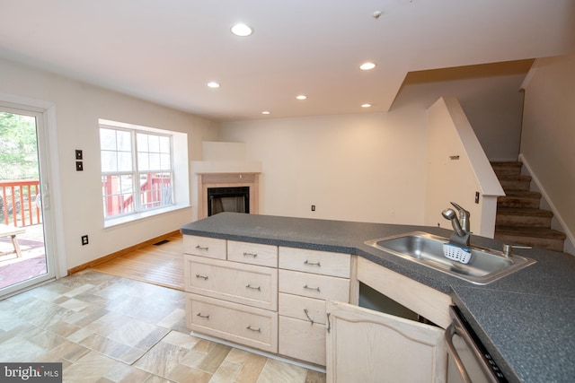 kitchen featuring dark countertops, plenty of natural light, recessed lighting, and a sink