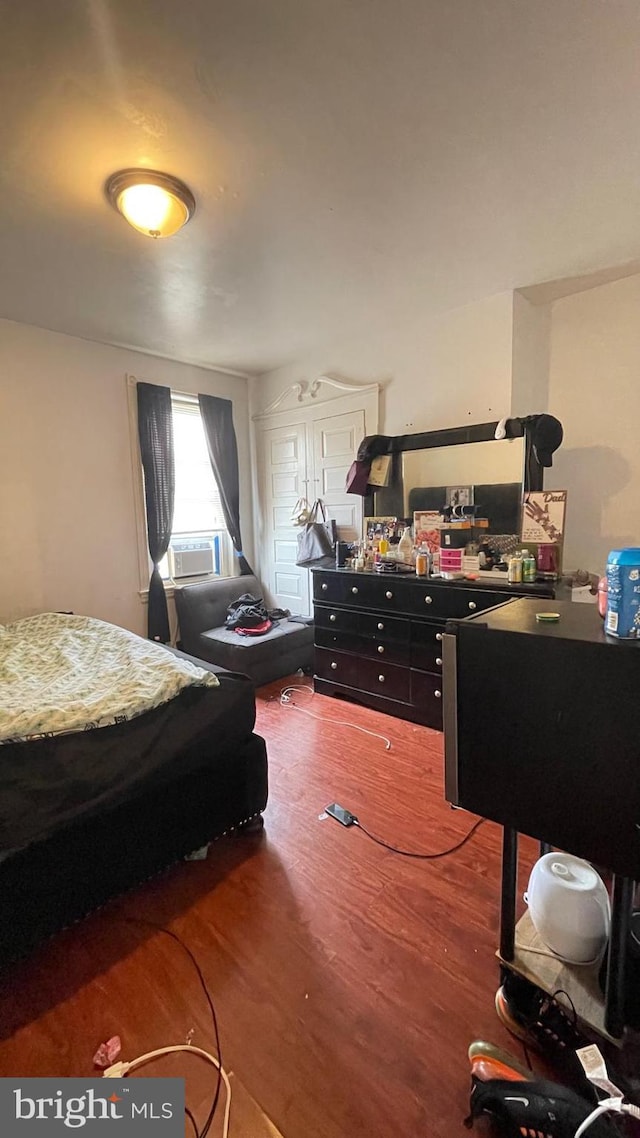 bedroom featuring cooling unit and wood finished floors