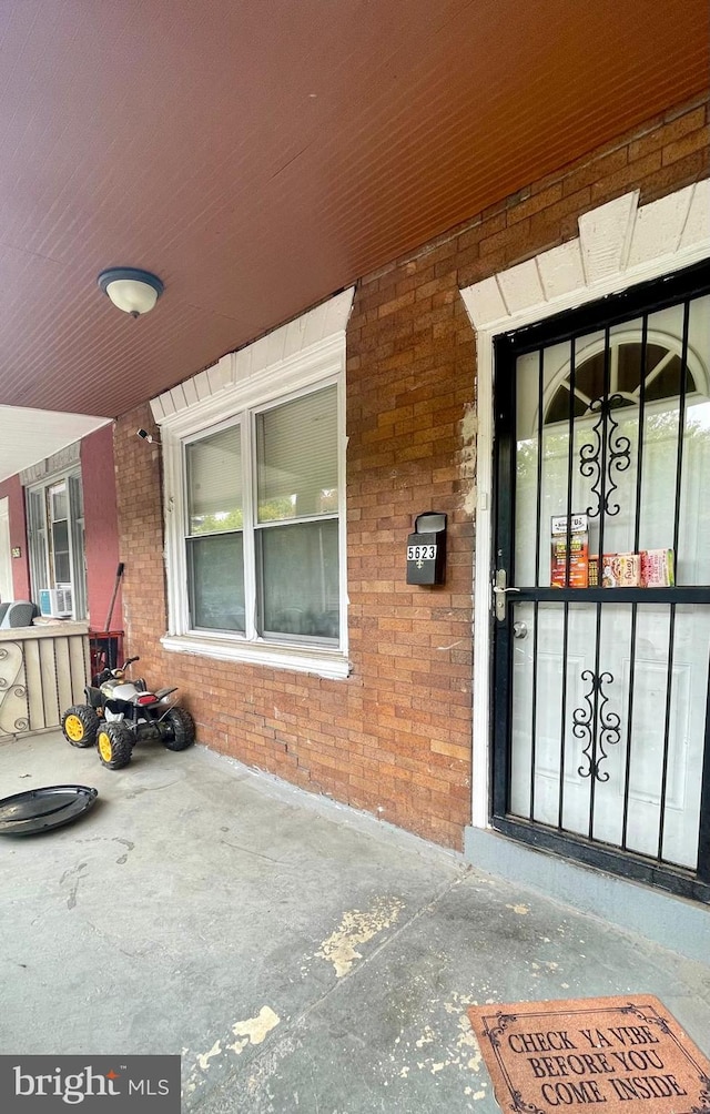 property entrance featuring brick siding