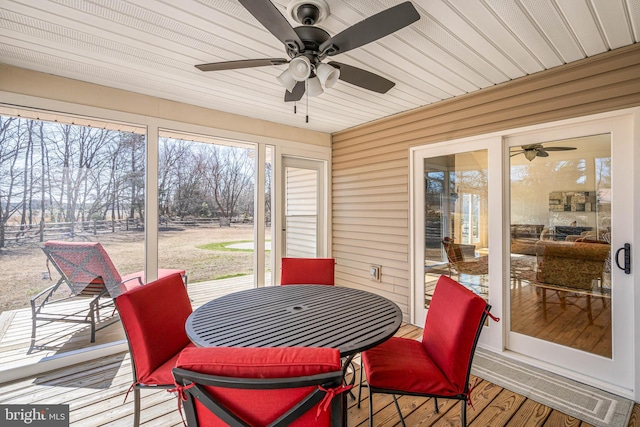 sunroom / solarium with a healthy amount of sunlight and ceiling fan