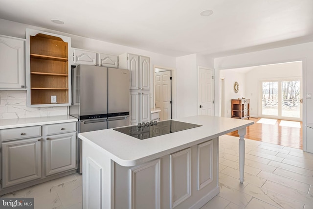 kitchen with gray cabinetry, a kitchen island, marble finish floor, black electric cooktop, and open shelves